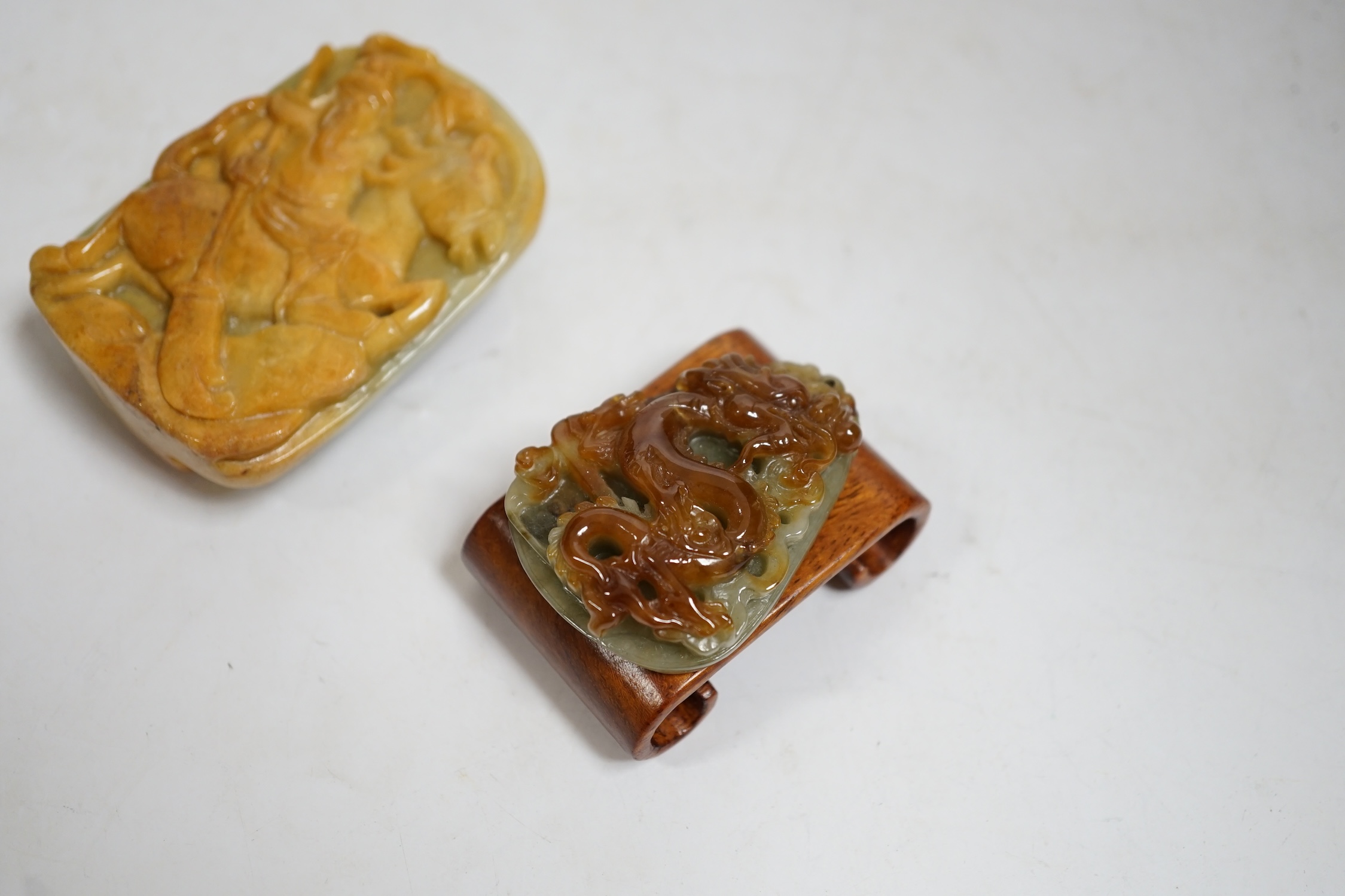A Chinese jadeite belt buckle and a plaque carved with a dragon, largest 6.5cm high. Condition - good